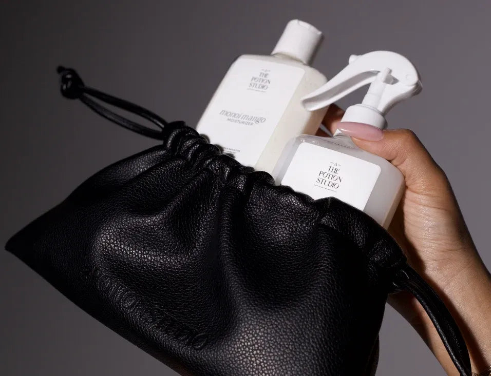The Potion Studio haircare essentials in a black drawstring bag