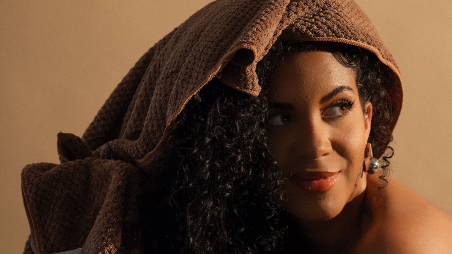 Woman with curly hair wearing a textured hair towel