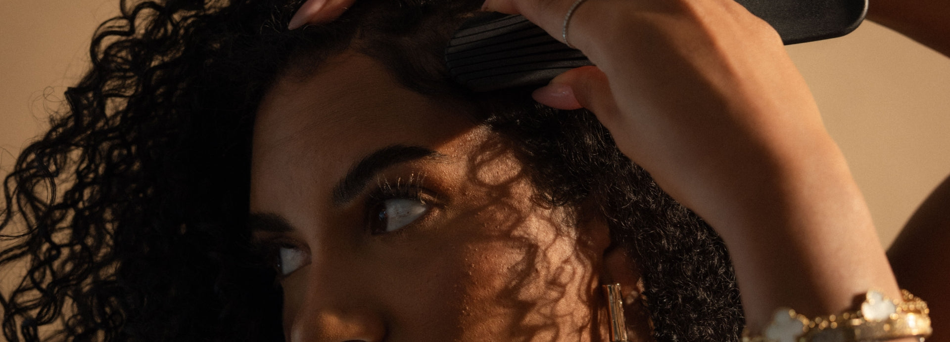 Woman brushing her curly hair